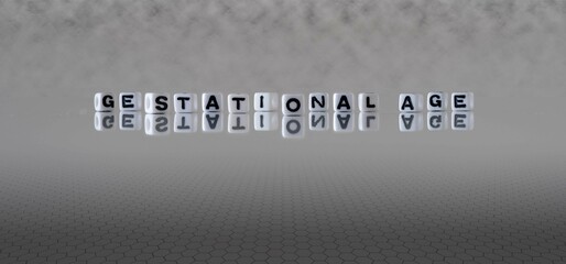 gestational age word or concept represented by black and white letter cubes on a grey horizon background stretching to infinity