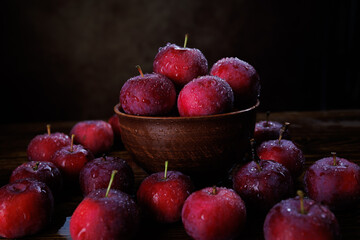Clay plate with red apples. Background from ripe red apples.