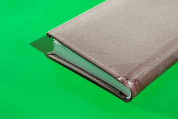 Dusty old notepad on light green background