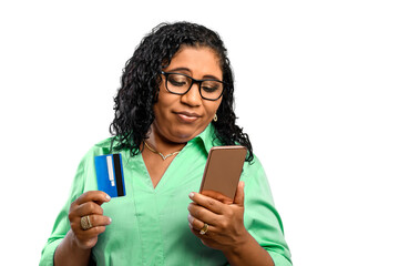woman holds debit card and speaks cell phone with dismayed, sad expression