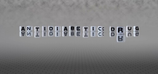 antidiabetic drug word or concept represented by black and white letter cubes on a grey horizon background stretching to infinity
