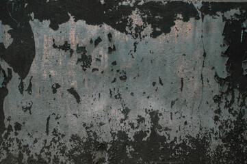 Old wall with peeling paint, uneven grungy vintage background close up, grunge texture