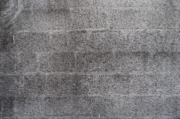 brick wall covered with gray decorative plaster, grungy vintage background closeup, grunge antique texture.