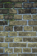 Faded old red brick wall, wide rough vintage texture. Dirty wall with grunge rectangular blocks, close-up, grungy texture of blackened bricks.