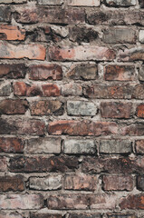 Faded old red brick wall, wide rough vintage panoramic texture. Dirty wall with grunge rectangular blocks, close-up, grungy texture of blackened bricks