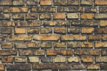Dirty brown brick wall, grunge, close-up, rough texture of fired clay material, mold showing through