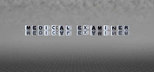medical examiner word or concept represented by black and white letter cubes on a grey horizon background stretching to infinity