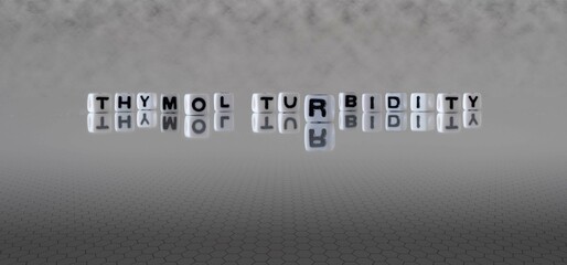 thymol turbidity word or concept represented by black and white letter cubes on a grey horizon...