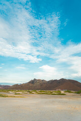 amazing landscape with mountains, a beautiful sky and beach sand