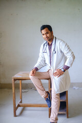 Bangladeshi young doctor in white apron and stethoscope in neck. South asian medical student with a confident look 