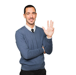 Young man making a number four gesture