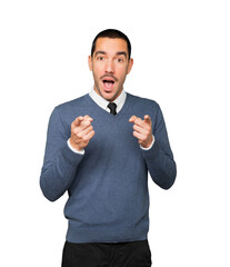 Amazed young man pointing at you with his finger