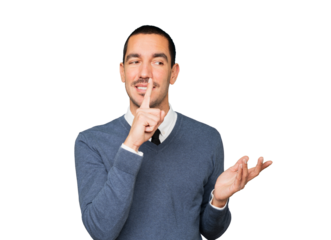 Happy young man asking for silence gesturing with his finger