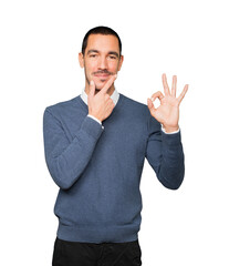Worried young man doubting and making a gesture of approval