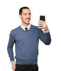 Happy young man taking a selfie with his mobile phone
