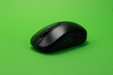 Wireless black mouse on a green isolated chroma key background