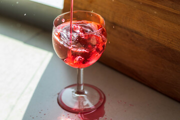 Shot of a red liquid being poured in to the wine glass. Concept