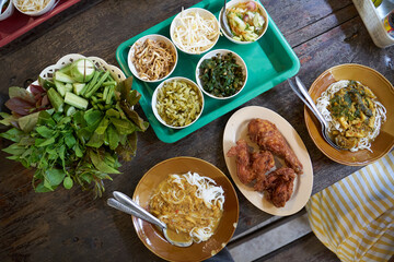 top view of rice noodle with fish curry on the table. Thai food.