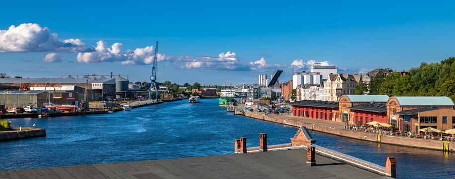 Lübeck, Germany - August 31, 2022: View of the river Trave and the harbor with shipyards.