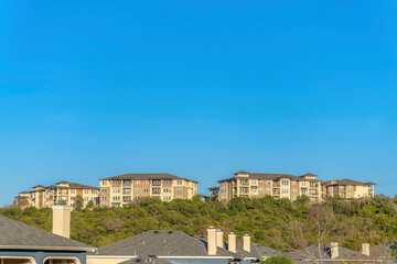 Scenic landscape of newly built houses by the Lake Austin against blue sky