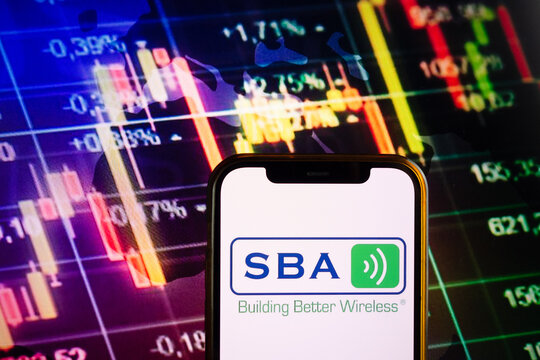 KONSKIE, POLAND - September 10, 2022: Smartphone displaying logo of SBA Communications company on stock exchange chart background