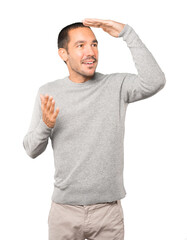 Astonished young man with a gesture of looking away