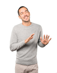 Friendly young man doing a gesture of keep calm