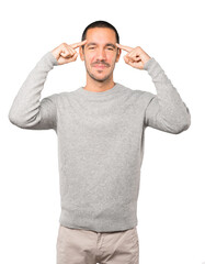 Fototapeta premium Happy young man doing a gesture of concentration
