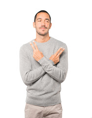 Happy young man making a victory gesture with his fingers