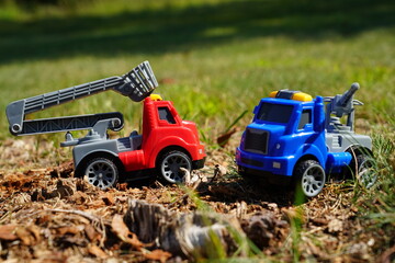 Young child's toy truck set sitting outside.