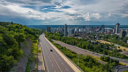 Aerial of the cityscape of Hamilton, Ontario with a display of a highway - obrazy, fototapety, plakaty