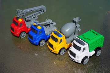 Young child's toy truck set sitting outside.