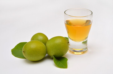 green walnuts and tincture of them on a white background