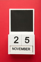 Wooden calendar 2022 with inscription 25 november on red background. Black friday. Vertical photo