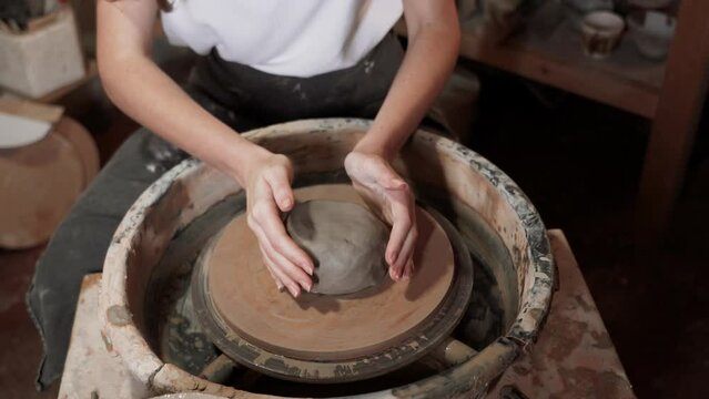 Creative young woman potter with long  hair making earthen dishes in workshop.Handmade hobby art and handicraft concept. 4k
