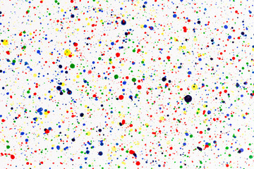 Paint splatters on bright material. Watercolor on white paper.