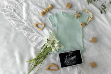 Mockup of baby bodysuit shirt . Baby Announcement. Pregnancy announcement background with blurred ....