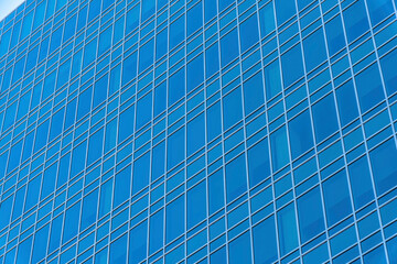 Blue building exterior with reflective glass facade in downtown Austin Texas