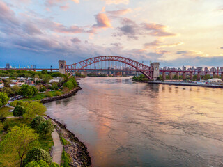 Aerial shot of Hellgate brige at sunset reflections in water Astoria New York City