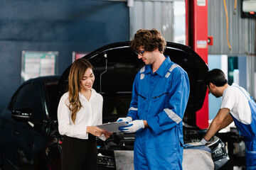 Car service and Automobile maintenance Concept, Car mechanic explaining repaired item and checking list to customer at automobile service center