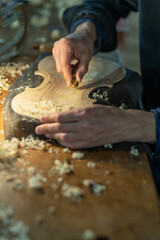 Close up of professional master artisan luthier working on creation of handmade violin in a...