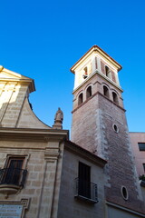 Fototapeta na wymiar Nice facade with tower and bell tower of the church of Saint Peter in Murcia