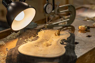 Cinematic recording of a violin with a small planer of careful detail work on fine quality wooden...