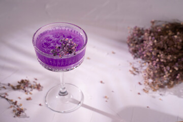 Drink with vodka gin cocktail and purple lavender dried flowers. Cold summer drink
