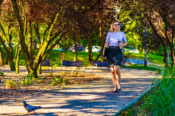 Fototapeta premium Coffee break - beautiful woman resting in city park 