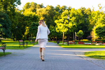 Beautiful woman walking in city park
