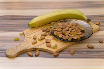 Almond, raisin and banana on the cutting board