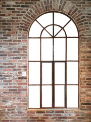 Antique arched window on brick wall isolated on white 