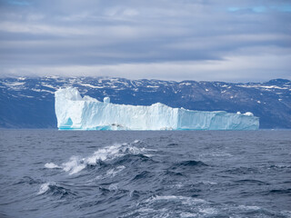 Enormous icebergs with sculptural forms of great beauty crowding the waters of the Disko Bay north of the Artic Circle near Ilulissat, Western Greenland