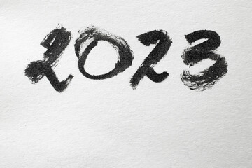 2023 number written with black ink on white paper